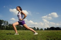 a Woman Stretching Outside Before Exercising