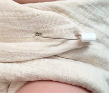 pinned muslin diaper close-up