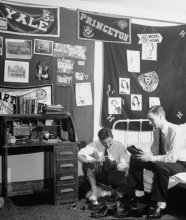 vintage college guys shining shoes in dormitory area